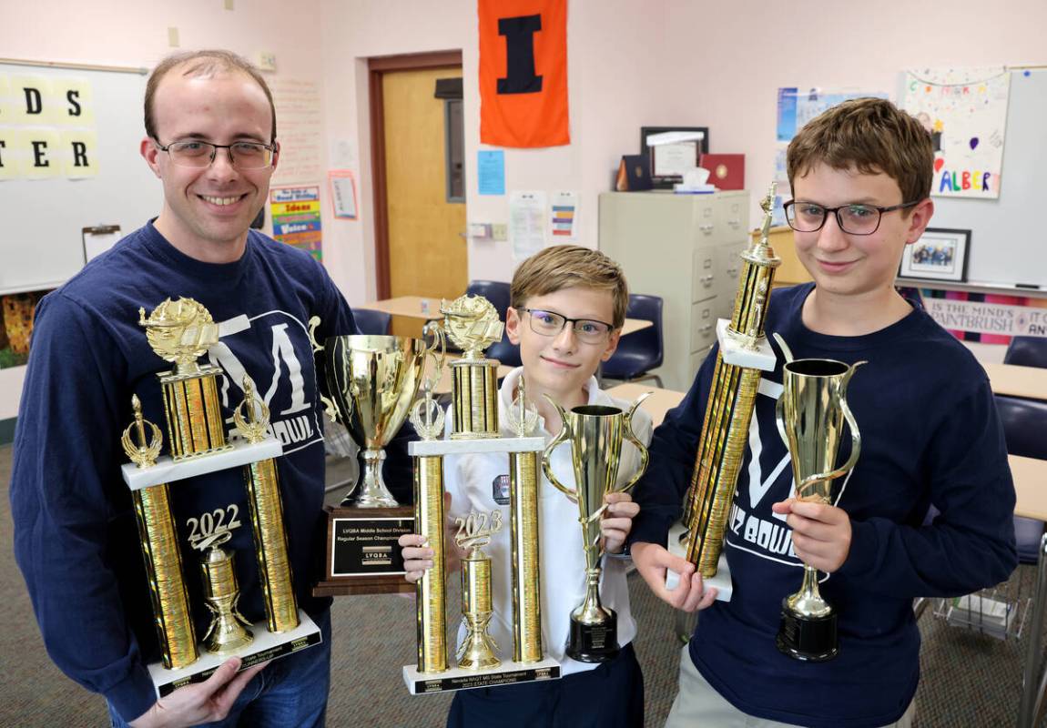 English teacher and quiz bowl coach Dr. Matt Albert, from left, sixth grader William Russman an ...