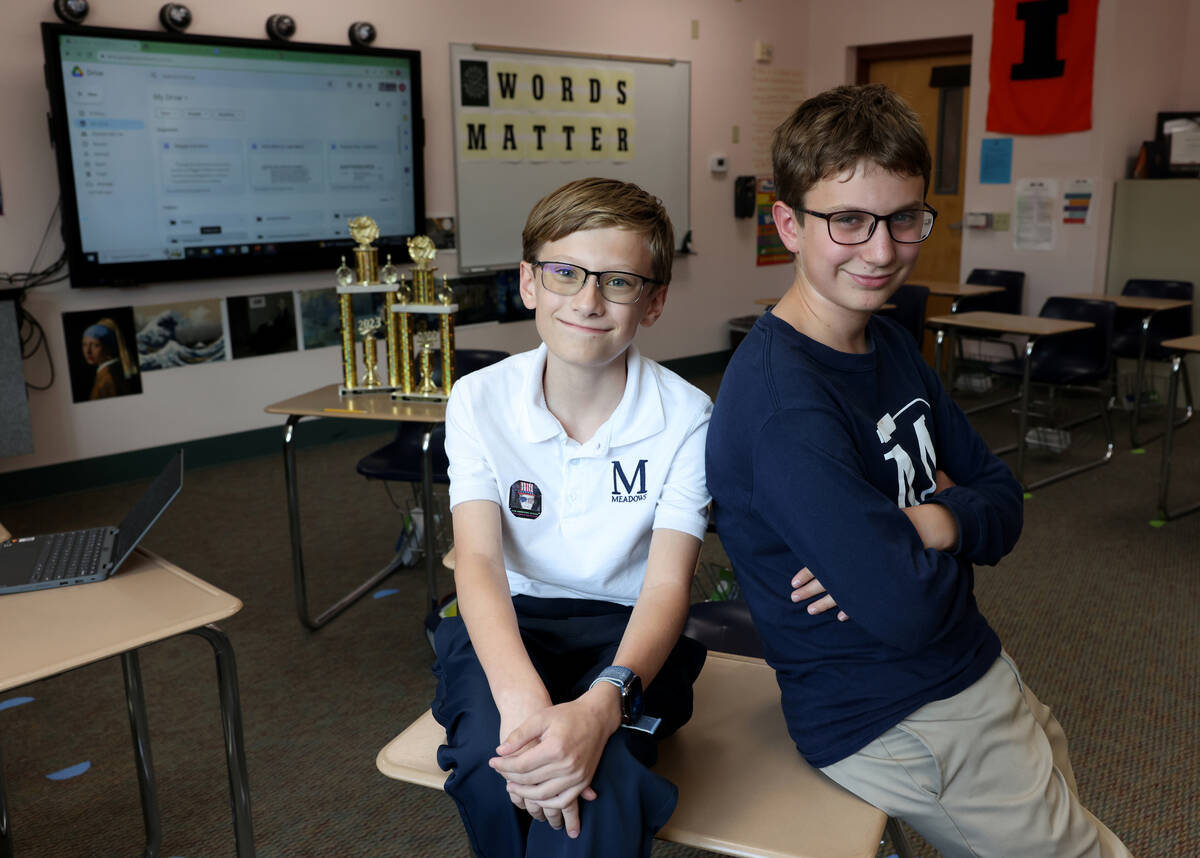 Seventh grader Elliot Lefebvre, left, and pose for a photo at The Meadows School in Las Vegas ...