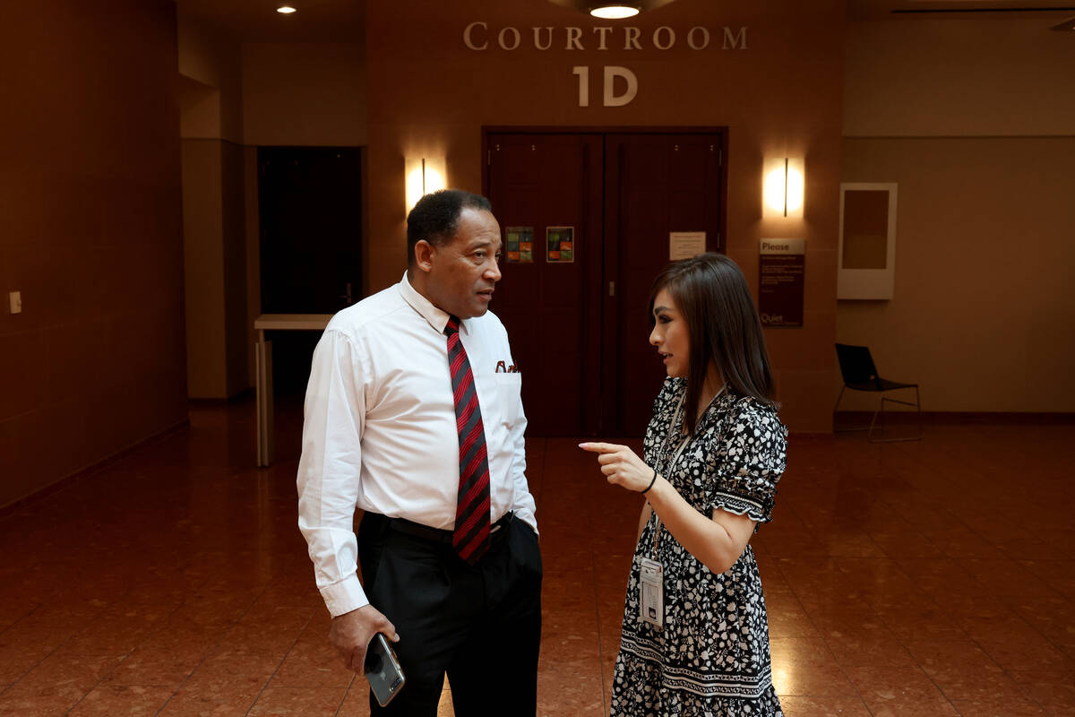 Burke Hall, left, talks to housing advocate Stephany Garcia outside eviction court at the Regio ...