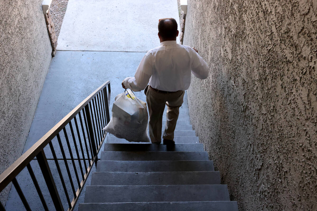 Burke Hall takes out the trash at his Las Vegas apartment after finding out that his past due r ...