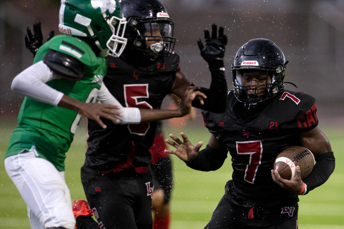 Las Vegas running back Torrell Harley (7) runs the ball while cornerback Treshawn Bush (5) keep ...