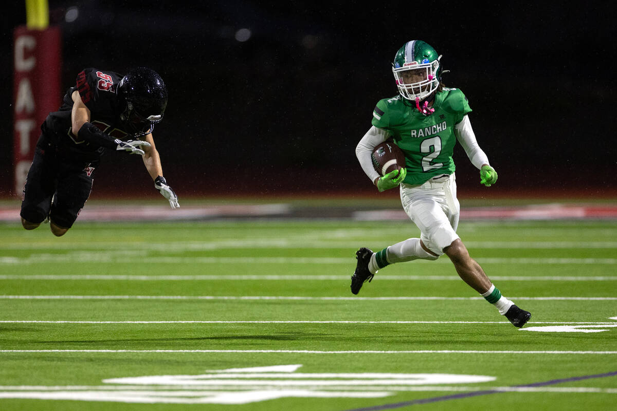 Rancho's Zachary Campbell (2) evades a tackle from Las Vegas cornerback Darientae Fryman (35) d ...