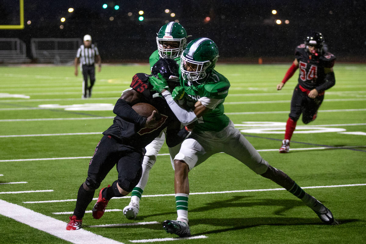 Las Vegas wide receiver Mychael Walker (6) is pushed out of bounds by Rancho's Victor Arellano, ...