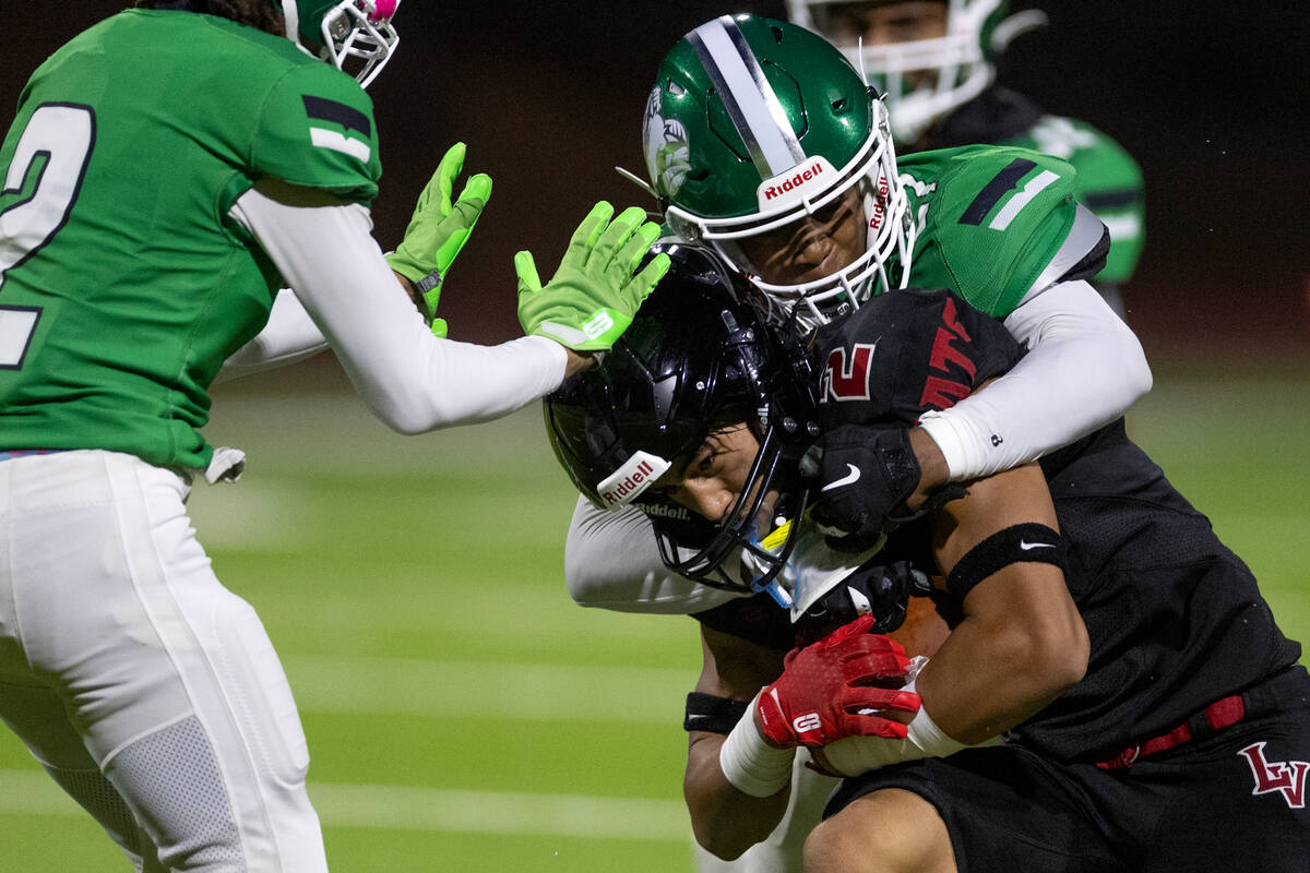 Rancho's Da'shawn Jones (27) takes down Las Vegas wide receiver Tommy Vibabul (2) during the se ...