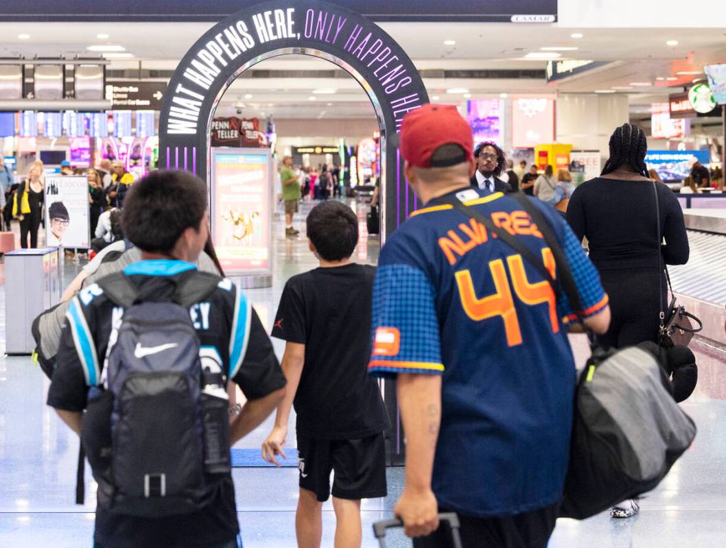 Arriving passengers head to baggage claim area at Terminal 1 of Harry Reid International Airpor ...