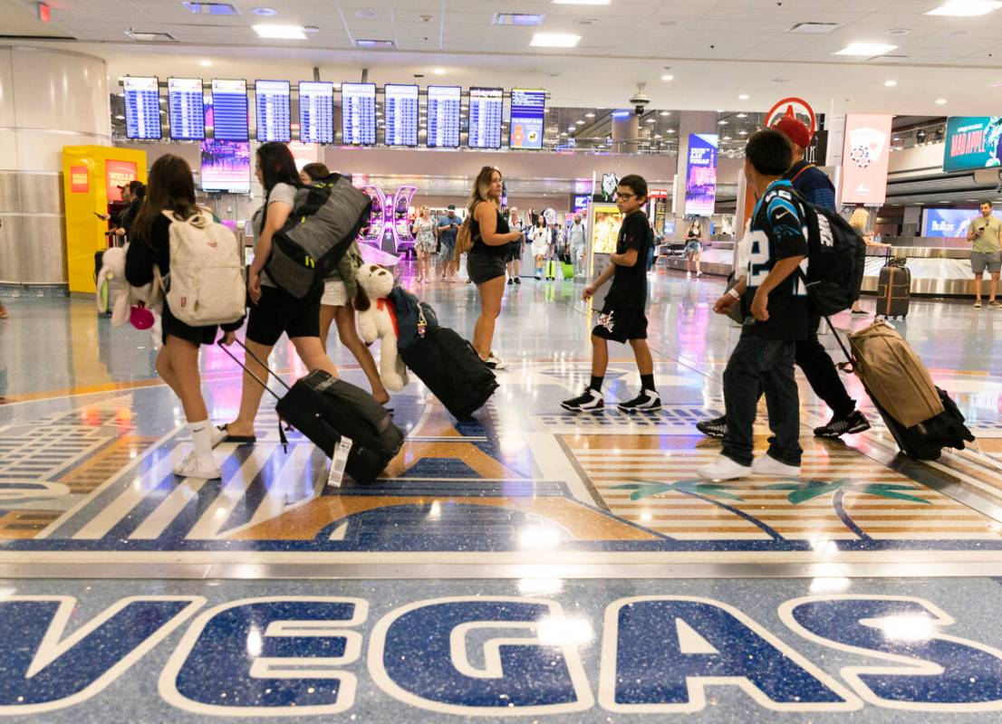 Arriving passengers head to baggage claim area at Terminal 1 of Harry Reid International Airpor ...