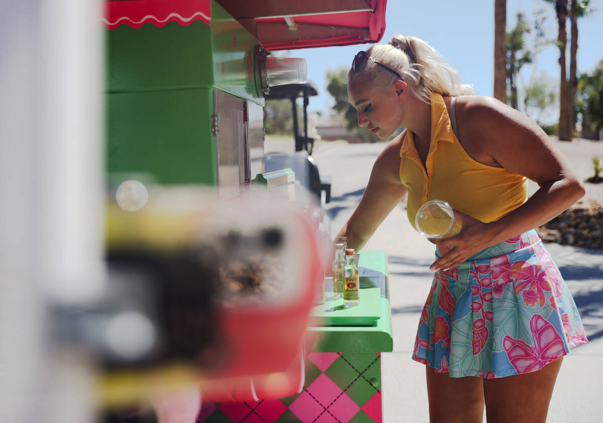 Cass Holland, a cart girl with a massive TikTok following, prepares drinks for customers at Chi ...