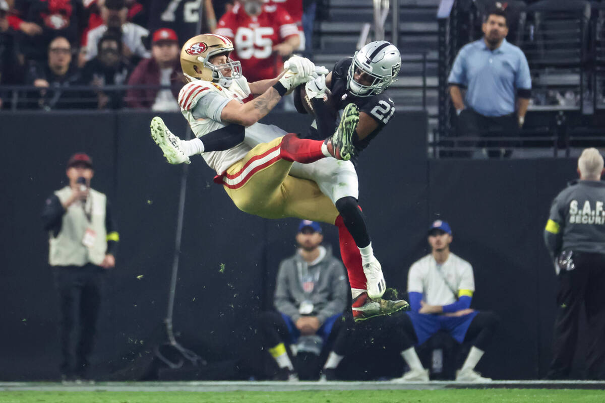 Raiders cornerback Amik Robertson (21) intercepts a pass intended for San Francisco 49ers tight ...