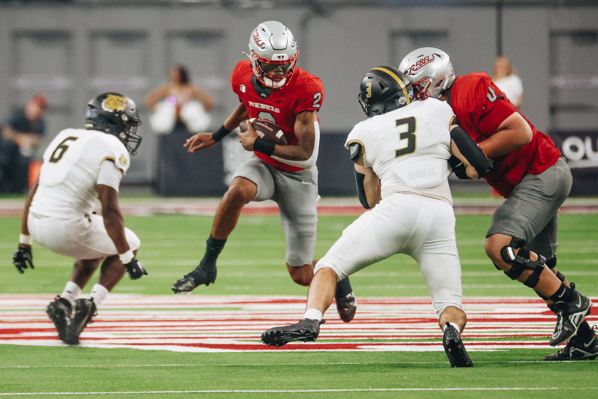 UNLV defensive back Jaxen Turner (2) runs the ball as he avoids Bryant’s defense during ...