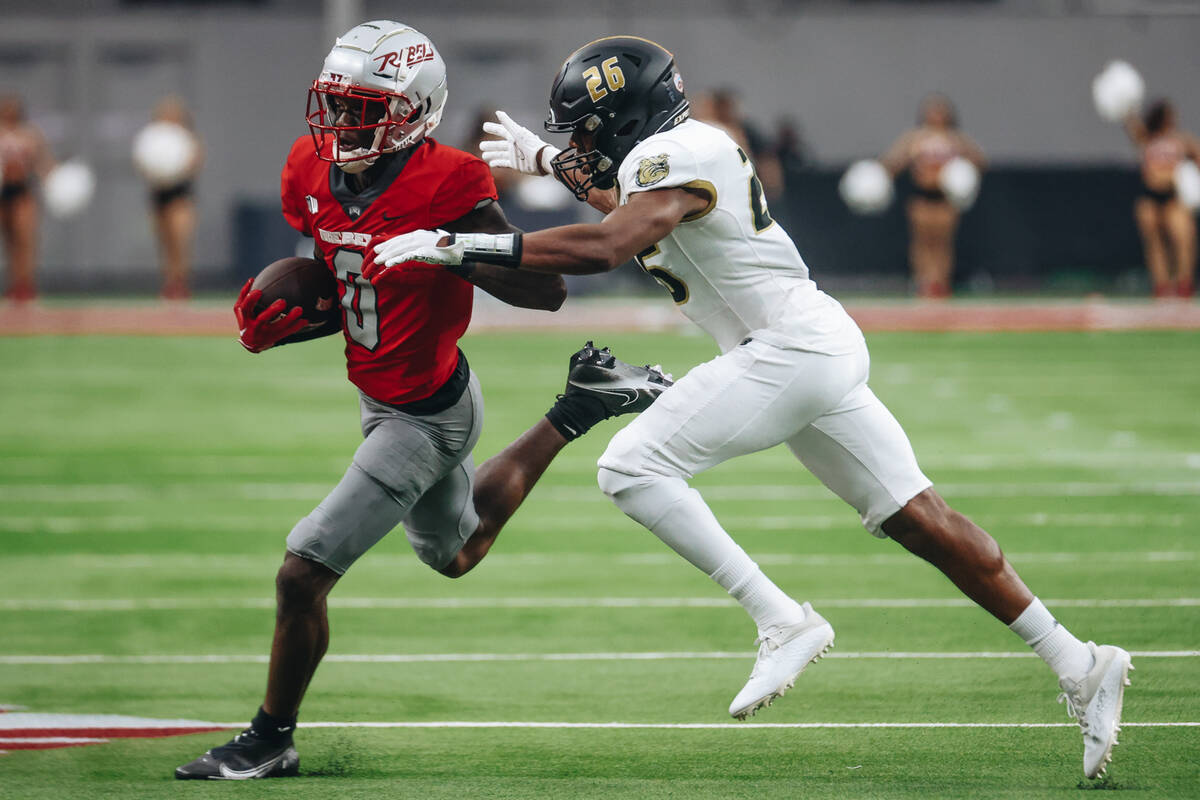 UNLV wide reciever Senika McKie (0) shreds off Bryant defensive back Tyler Haskins (26) during ...