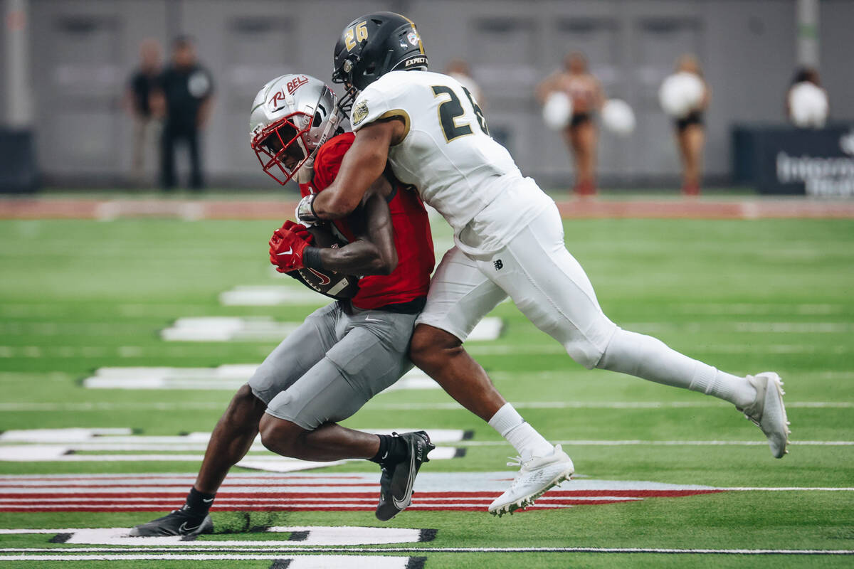 UNLV wide reciever Senika McKie (0) holds on to the ball as Bryant defensive back Tyler Ha ...