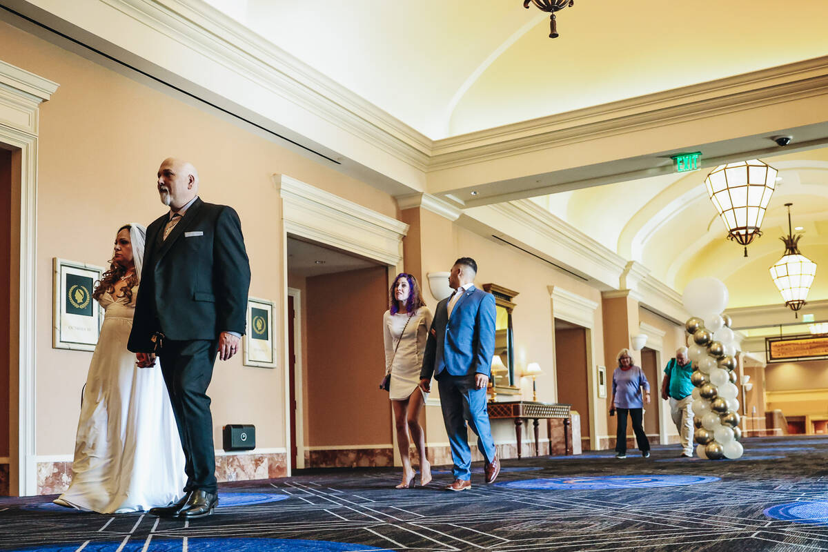 Couples enter a vow renewal ceremony inside of the Octavius Ballroom Caesars Palace on Sunday, ...