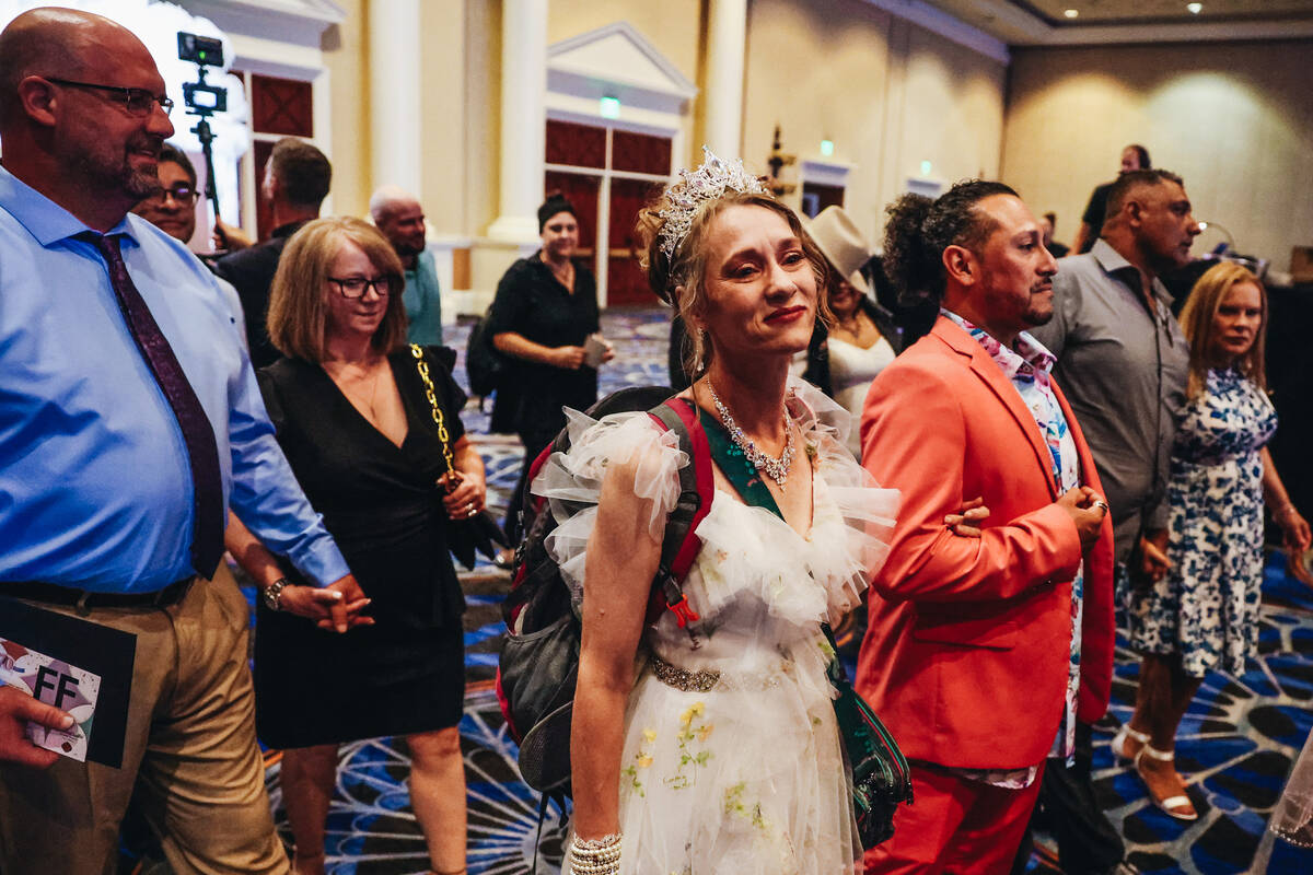 Couples walk into the Octavius Ballroom to renew their vows during a ceremony with 250 couples ...