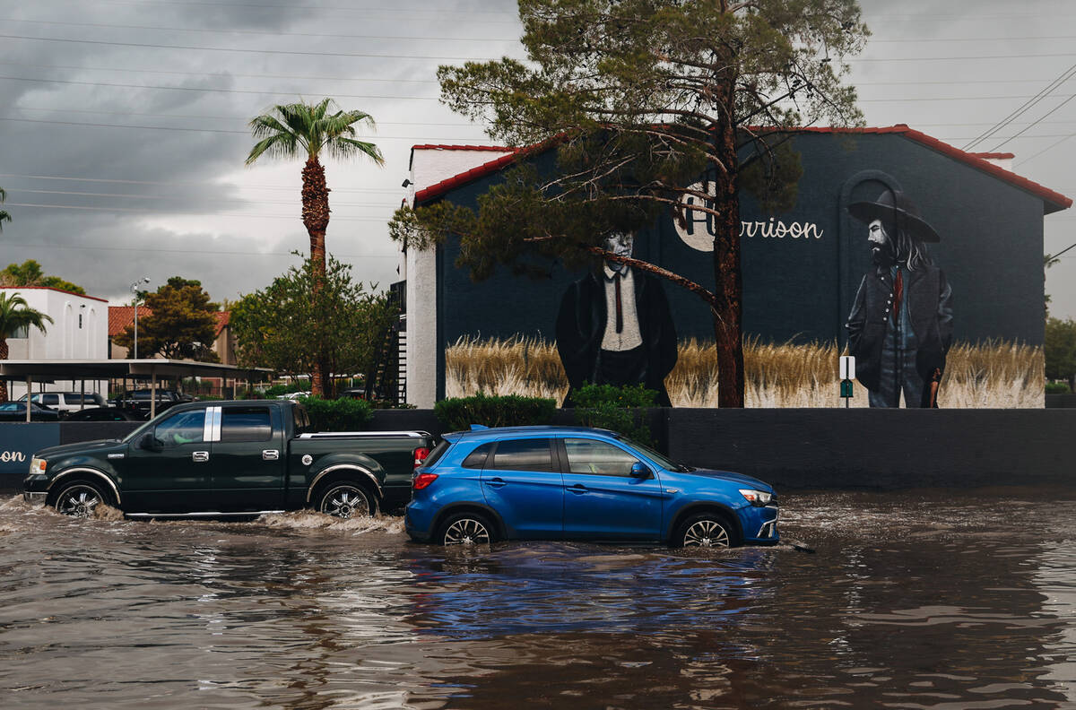 Cars drive through flood water on South Andover Street on Friday, Sept. 1, 2023, in Las Vegas. ...