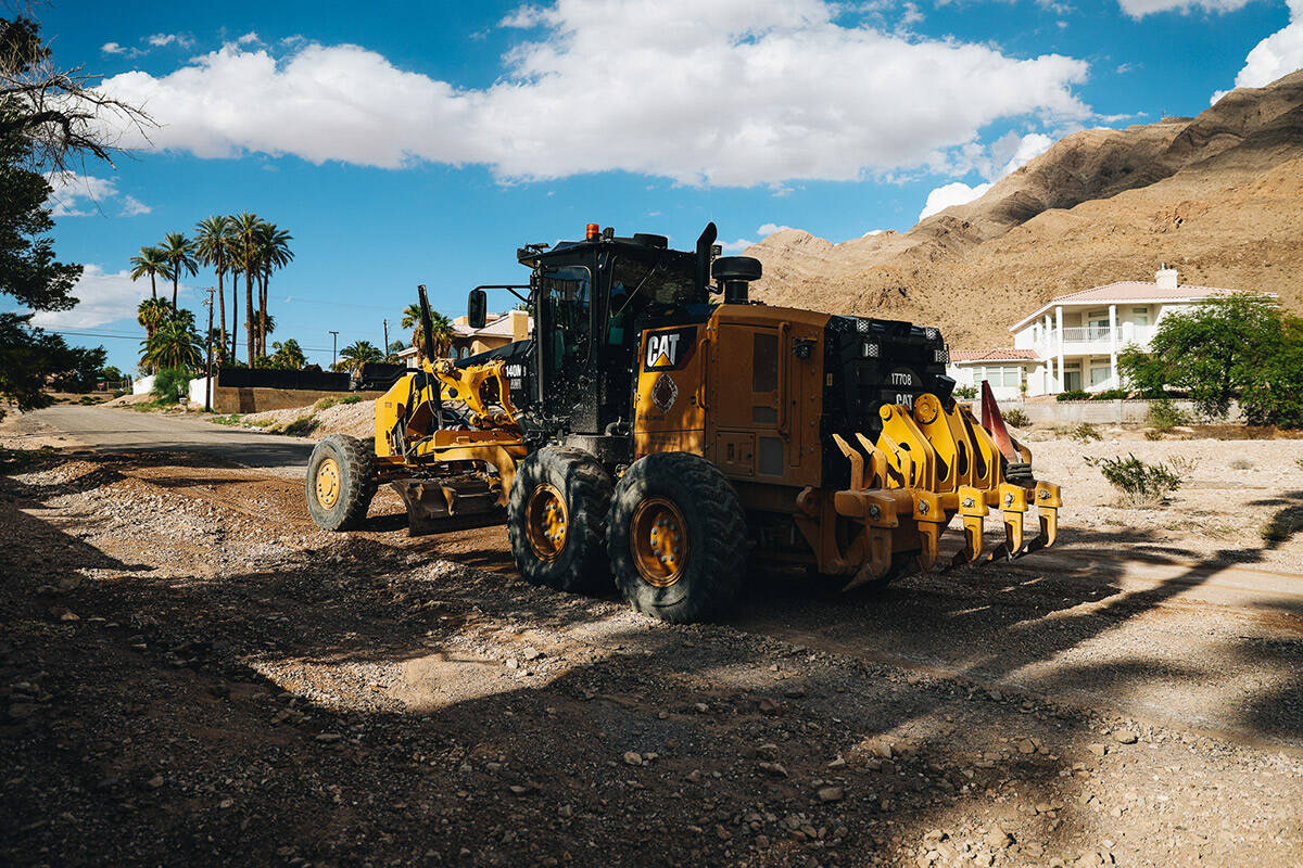 Rocks and debris are moved out of the road in a neighborhood outside of Frenchman Mountain on S ...