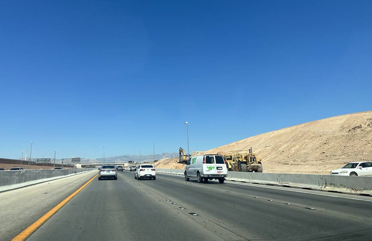 Crews working on a widening project of the 215 Beltway near Decatur Boulevard on Aug. 4, 2023. ...