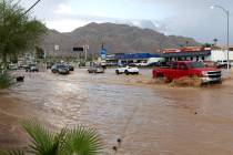 Traffic moves through flash flooding down East Lake Mead Boulevard on Saturday, Sept. 2, 2023, ...