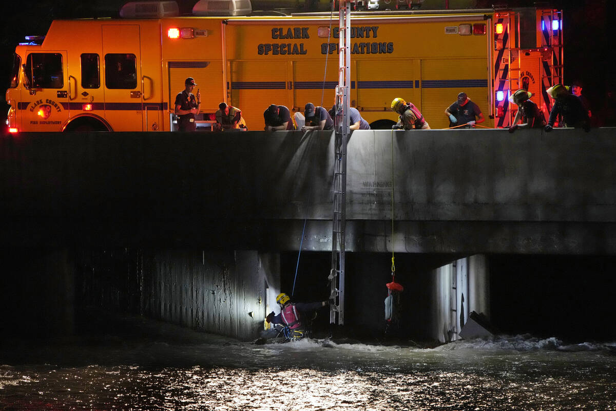 Clark County Fire Department officials search for a man who was trapped in floodwaters in a flo ...