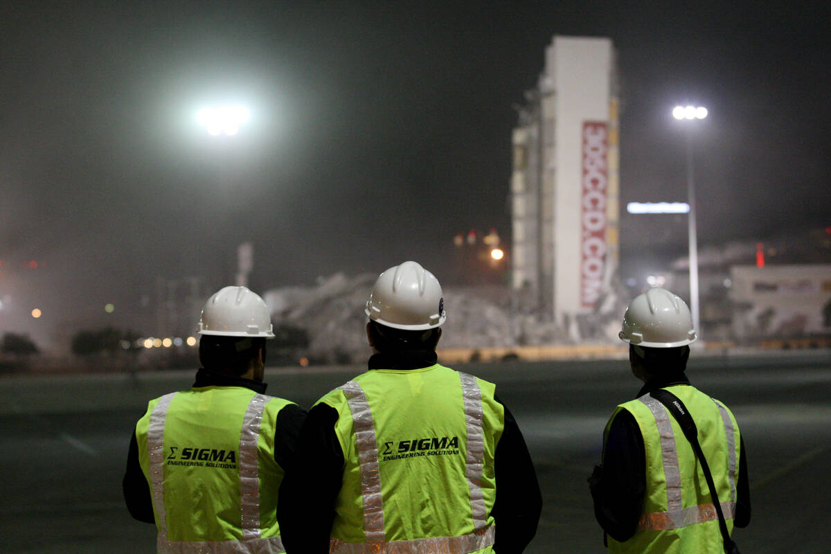 Members of the demolition team looking at the segment of the Clarion Hotel and Casino that fai ...