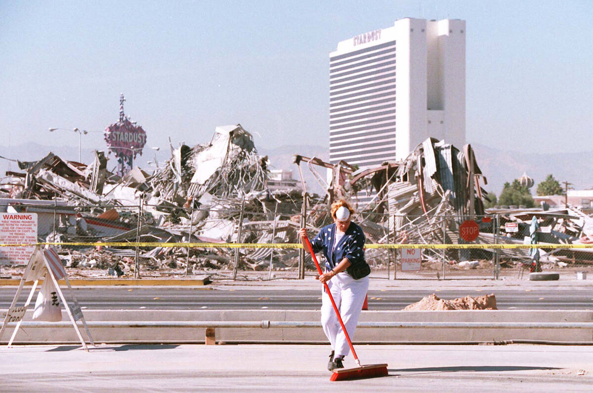 Adrea Davis, a Manpower employee, sweeps the parking lot at the Las Vegas Convention Center on ...