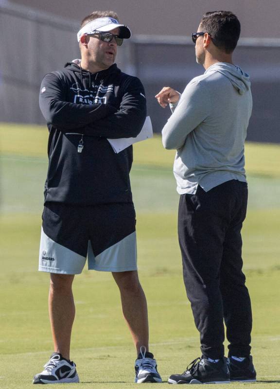 Raiders head coach Josh McDaniels, left, and general manager Dave Ziegler meet during practice ...