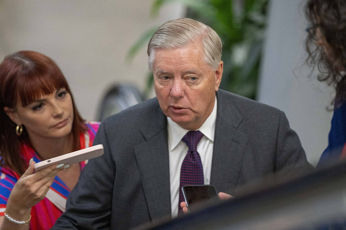 Sen. Lindsey Graham, R-S.C., speaks with reporters on his way to a vote on Capitol Hill, Wednes ...