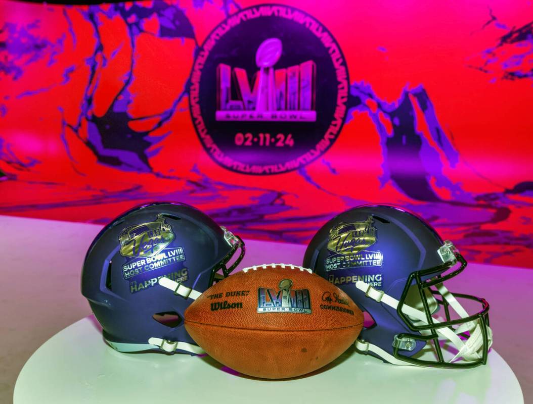 A football and helmets on display as the National Football League and the Las Vegas Super Bowl ...