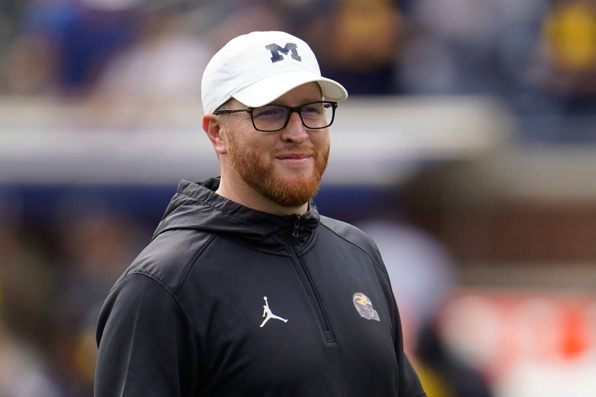 Michigan Special Teams Coordinator Jay Harbaugh watches before an NCAA college football game ag ...