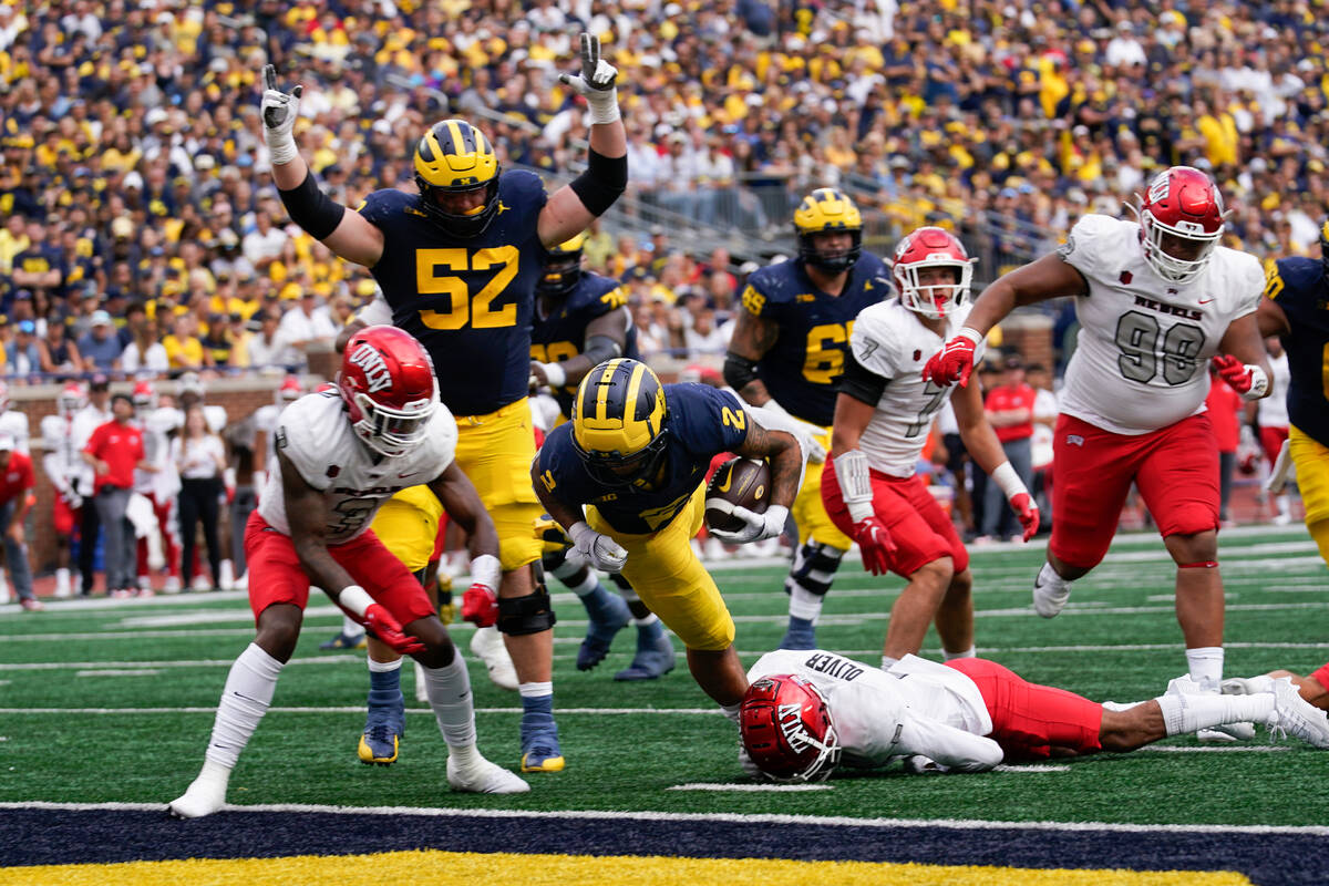 Michigan running back Blake Corum (2) scores on a two-yard touchdown run against UNLV in the se ...