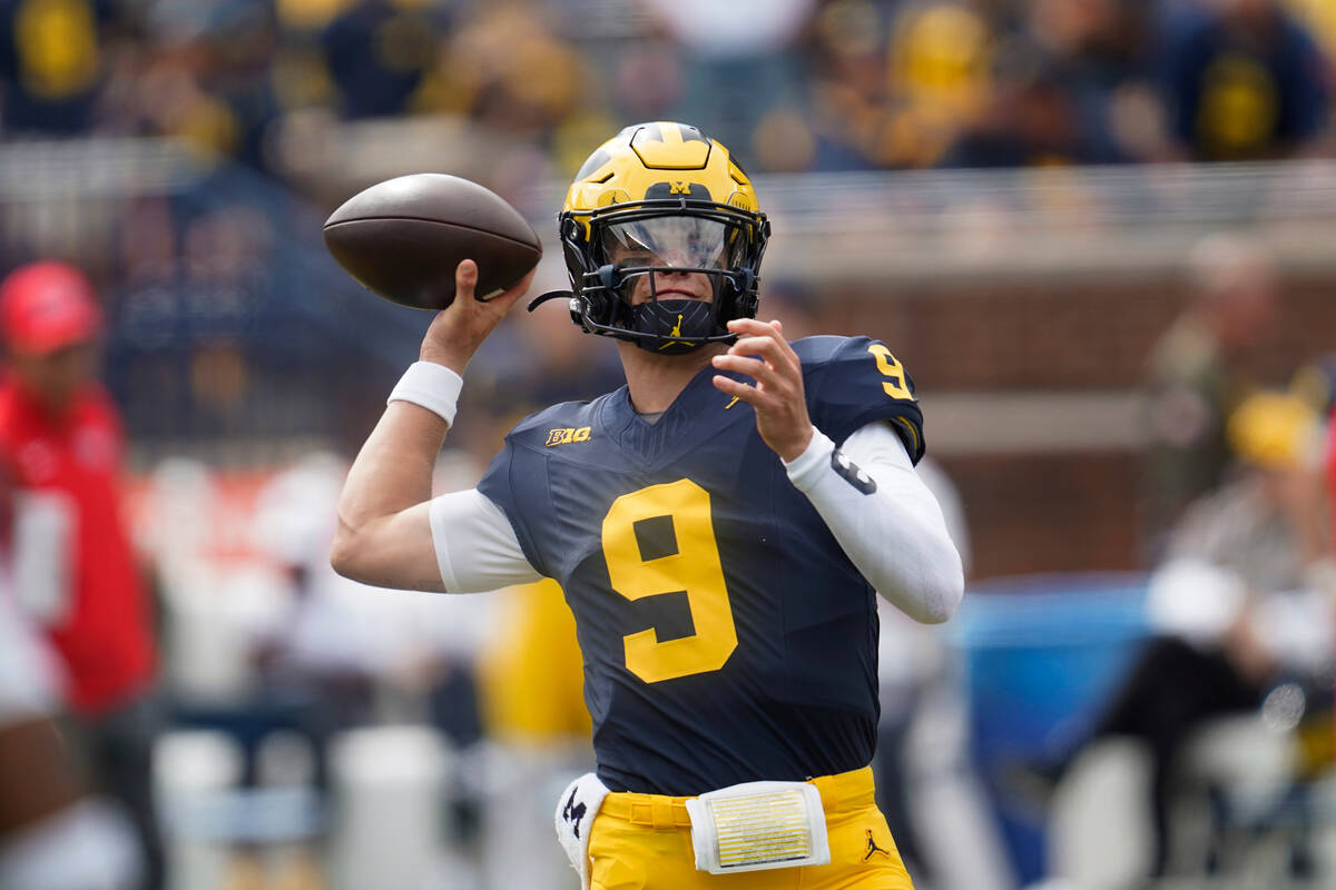 Michigan quarterback J.J. McCarthy (9) throws before an NCAA college football game against UNLV ...