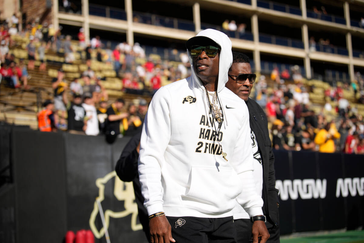 Colorado head coach Deion Sanders walks the perimeter of Folsom Field before an NCAA college fo ...