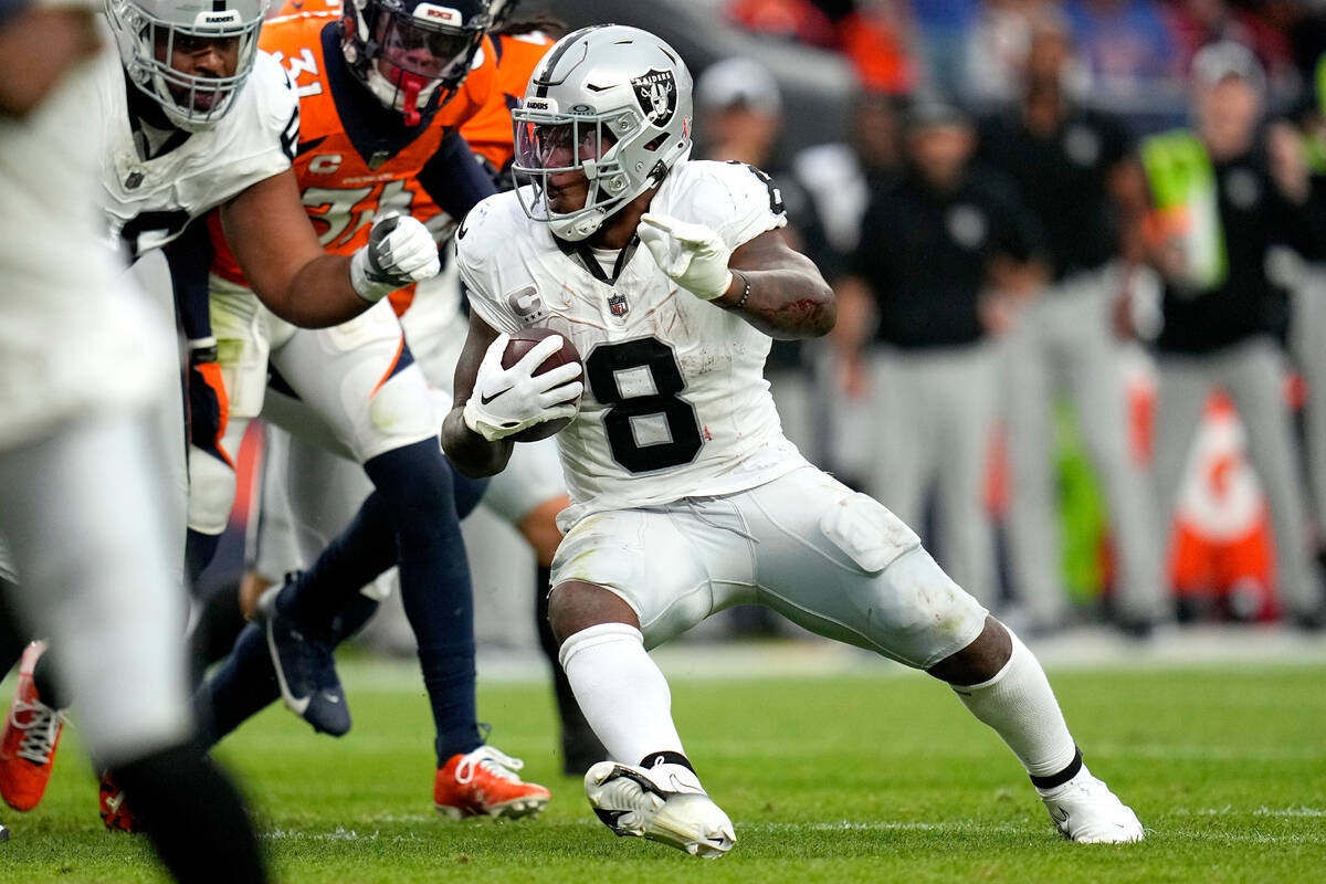 Las Vegas Raiders running back Josh Jacobs (8) runs the ball against the Denver Broncos during ...