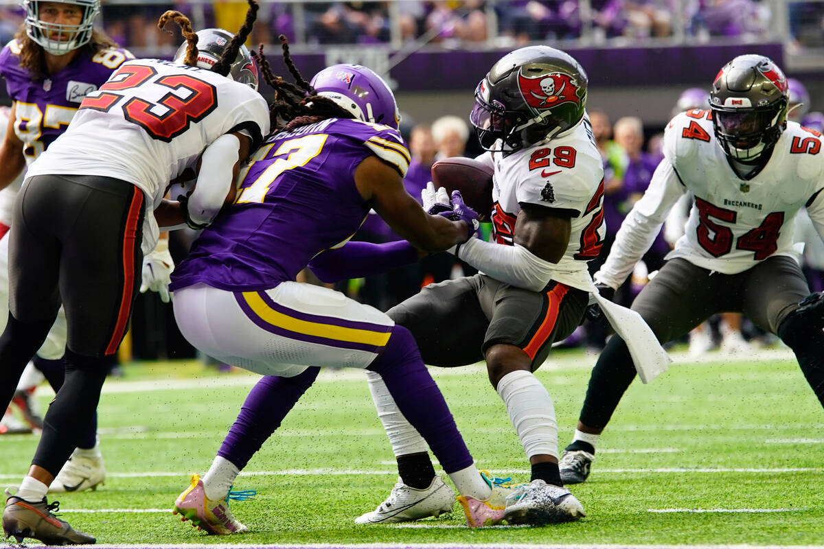 Tampa Bay Buccaneers safety Christian Izien (29) intercepts a pass intended for Minnesota Vikin ...