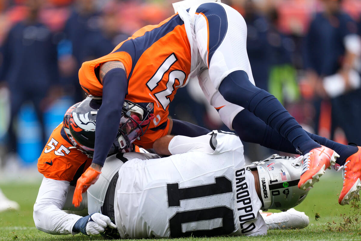 Denver Broncos safety Justin Simmons (31) and Broncos linebacker Frank Clark (55) tackle Las Ve ...