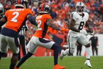 Las Vegas Raiders running back Josh Jacobs (8) runs the ball against the Denver Broncos of an N ...