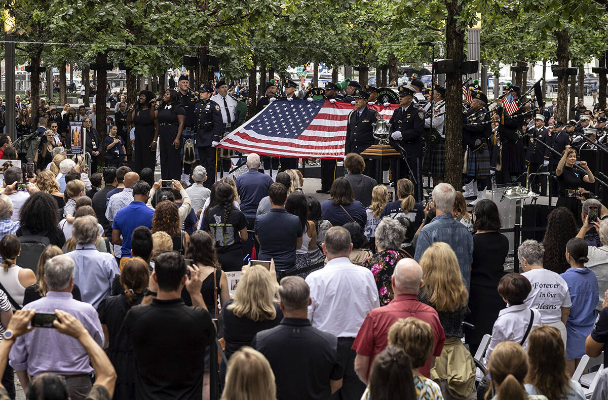 Members of New York Fire Department raise a US flag during the commemoration ceremony on the 22 ...