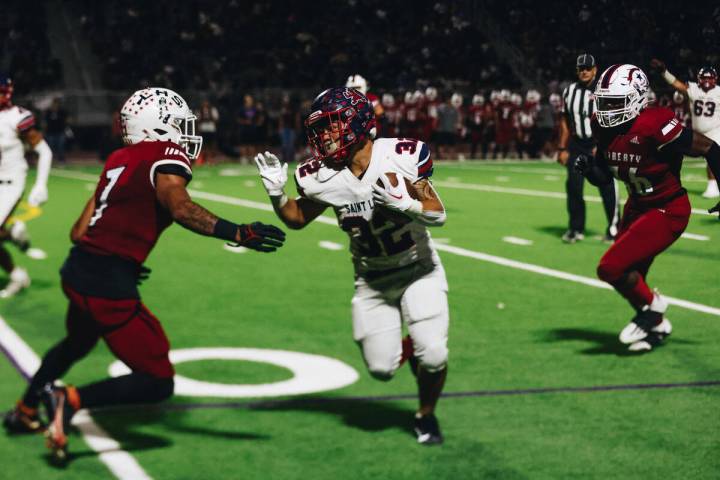 Liberty wide receiver Jayden Robertson (7) looks to tackle a St. Louis player during an Island ...