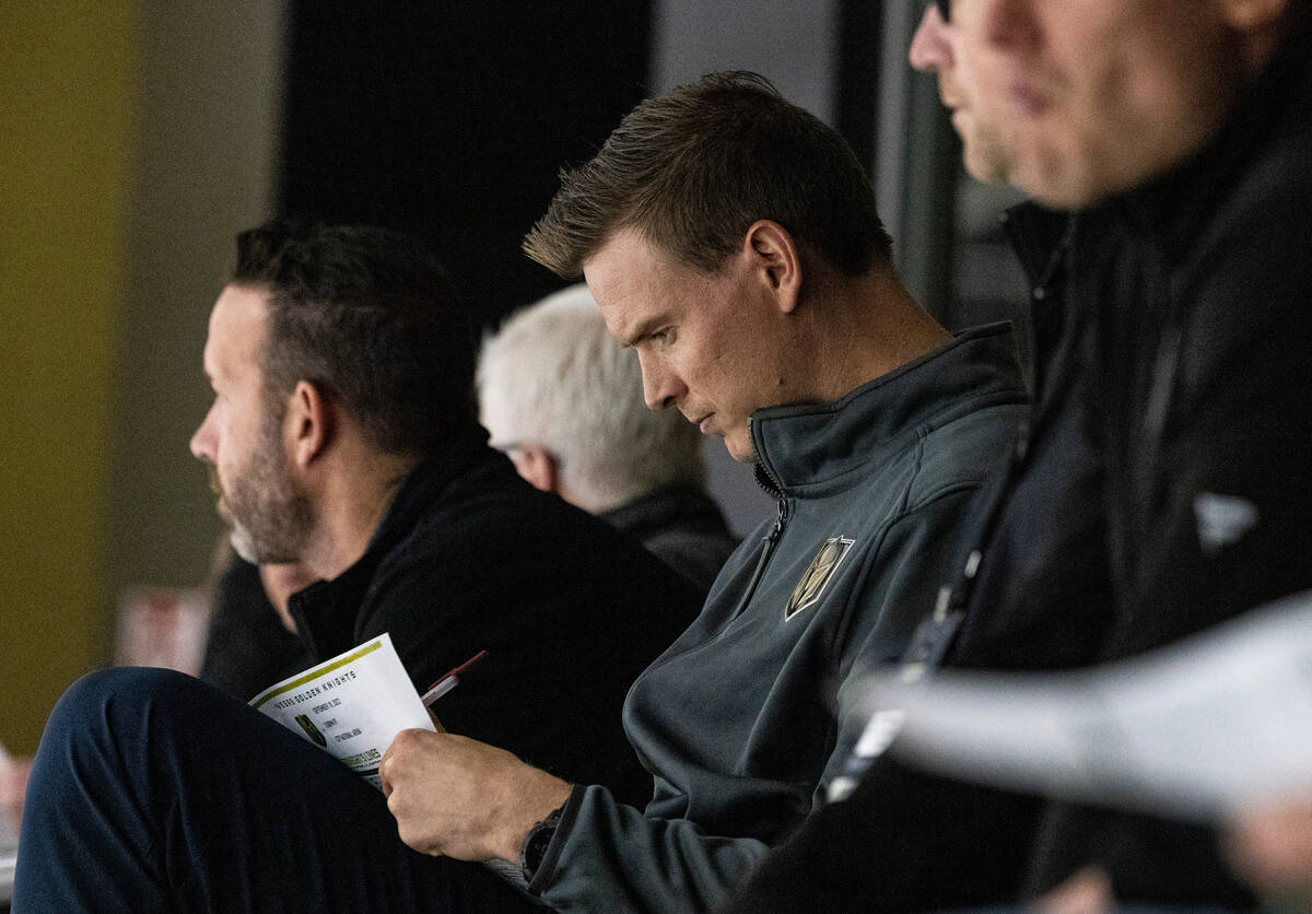 Golden Knights former defenseman Nick Holden, center, takes notes as he watches a rookie camp g ...