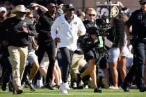 Colorado head coach Deion Sanders leads the team on to the field in the first half of an NCAA c ...