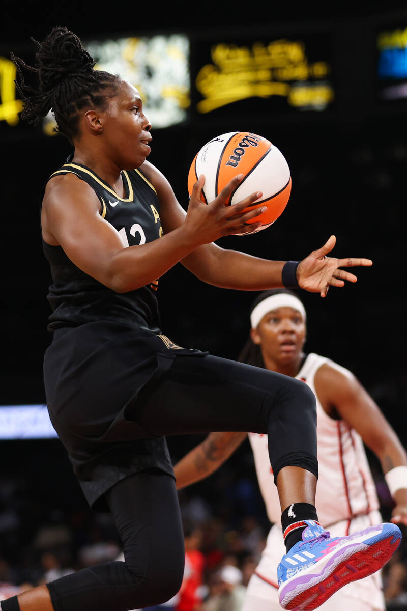 Las Vegas Aces guard Chelsea Gray (12) lunges to pass the ball during a WNBA game against the W ...