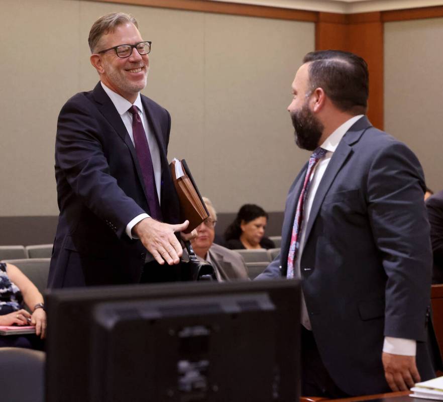 Bradley Schrager, an attorney for Clark County Education Association, left, shakes hands with C ...