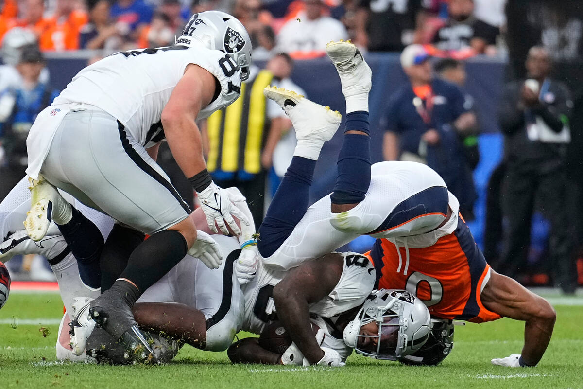 Las Vegas Raiders running back Josh Jacobs (8) is tackled by Denver Broncos linebacker Jonathon ...