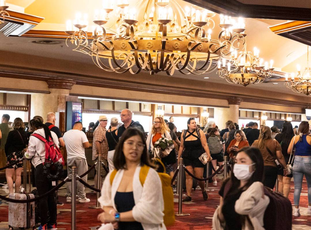 Hotel guests wait in line as they check in at Excalibur hotel- casino, on Thursday, Sept. 14, 2 ...