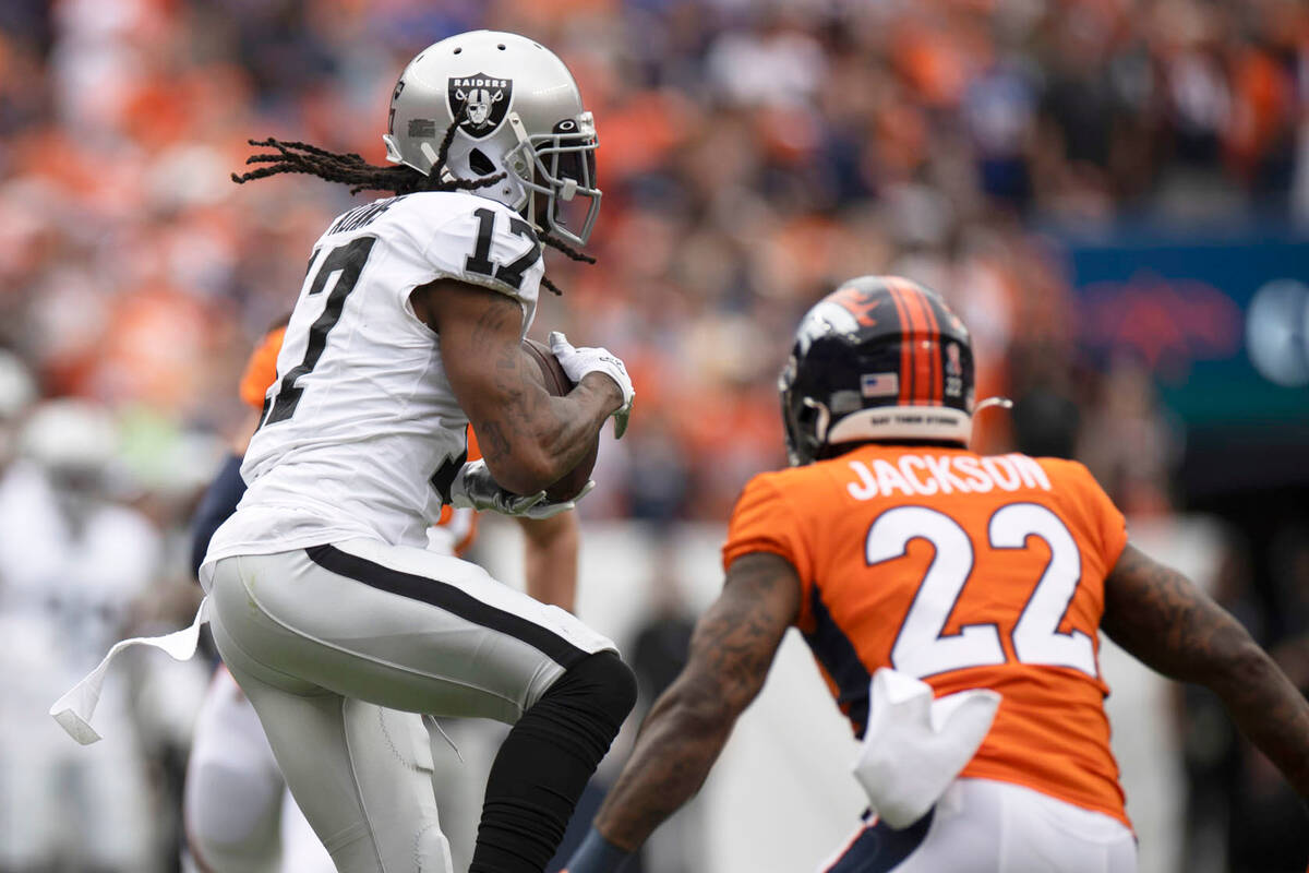 Raiders wide receiver Davante Adams (17) makes a catch for a fourth down conversion during the ...