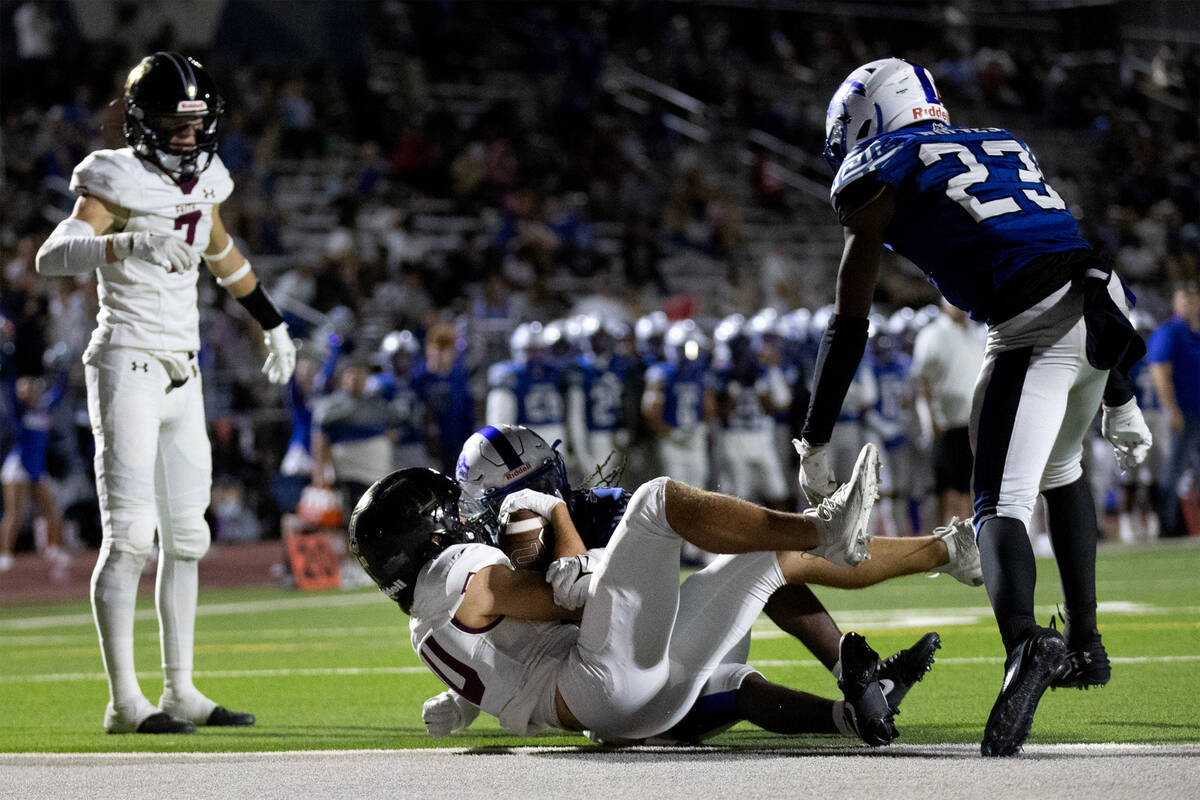 Faith Lutheran's Graham Radke (10) scores a touchdown to tie the game while Basic’s Syncere H ...