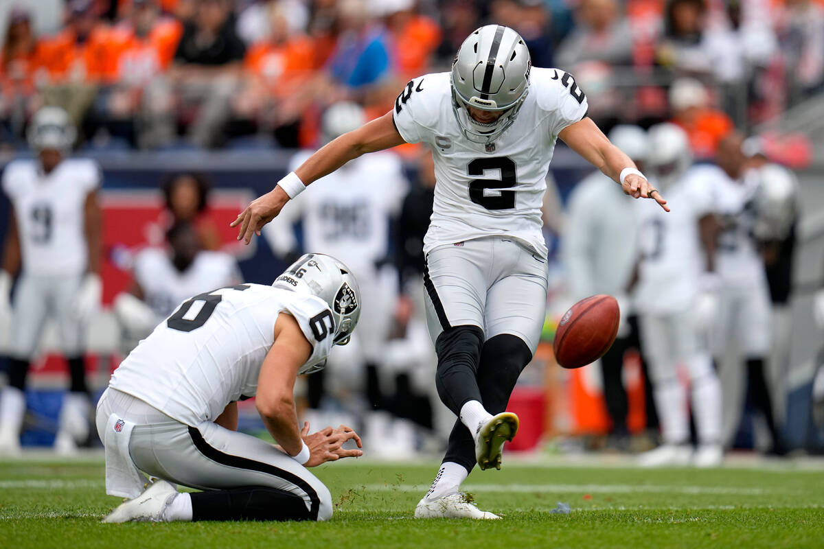 Las Vegas Raiders kicker Daniel Carlson (2) kicks a field goal as punter AJ Cole (6) holds duri ...