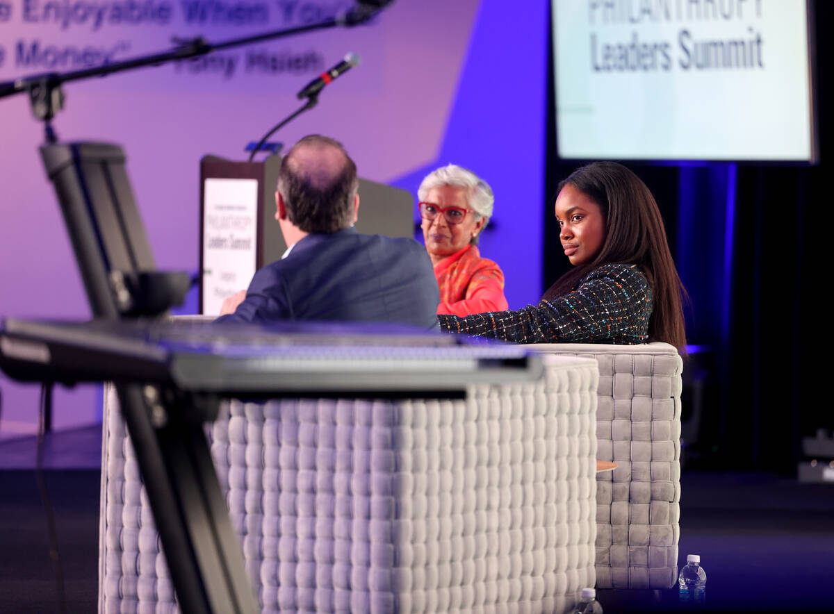 Moderator Punam Mathur, center, interviews Pilar Harris, senior director of corporate social re ...