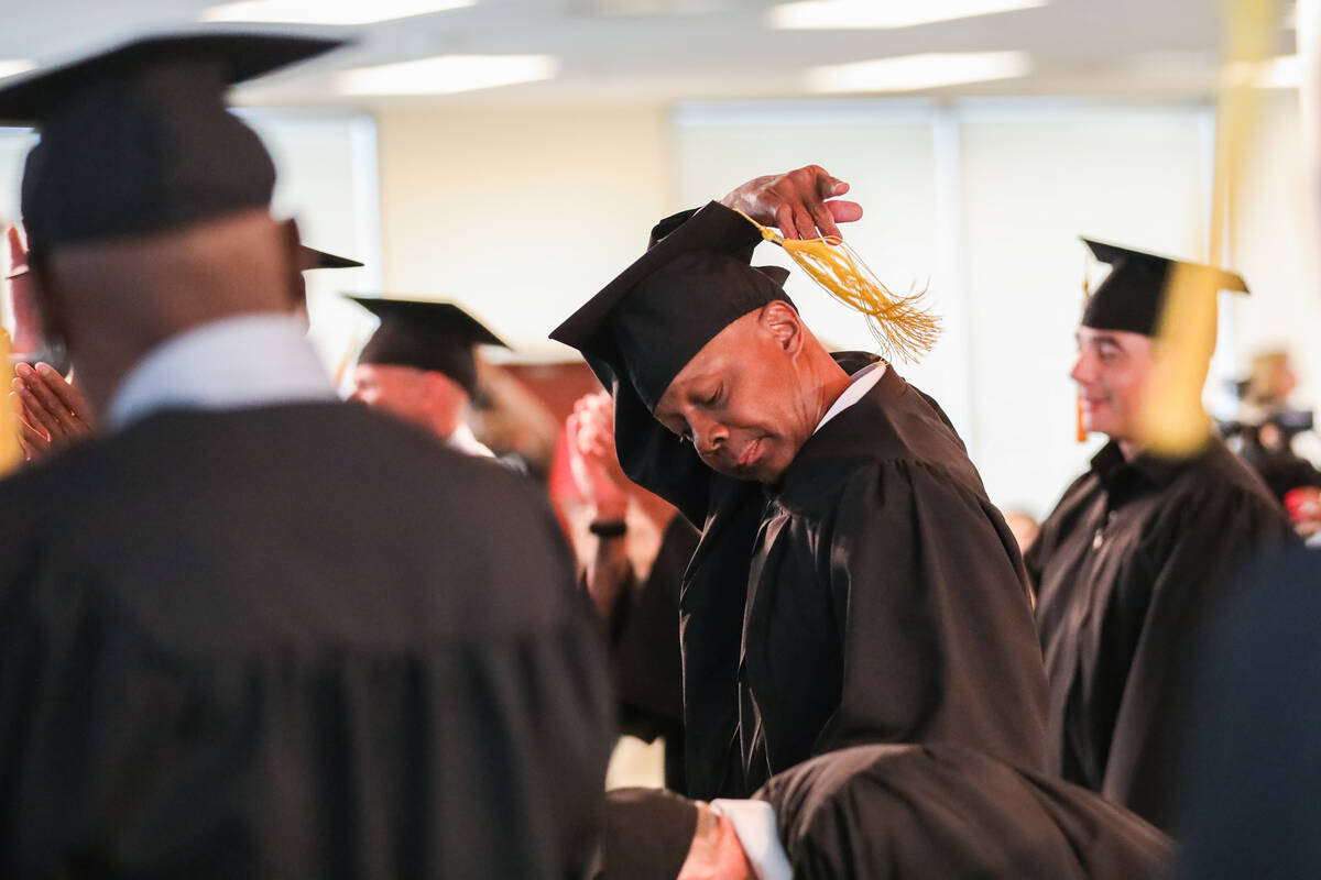 Arthur Gibbs flips his tassel during the graduation ceremony for completing the Law Enforcement ...