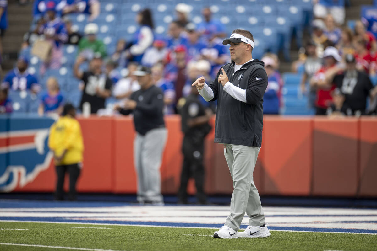 Raiders head coach Josh McDaniels gestures while on the field before an NFL game against the Bu ...