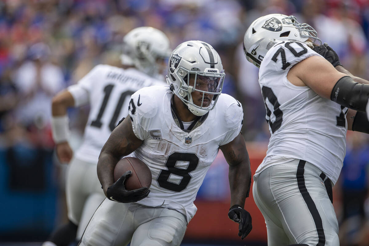 Raiders running back Josh Jacobs (8) looks for room to run against the Buffalo Bills during the ...